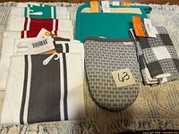 Overview of all kitchen linens with tags visible