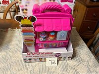 Front view of boxed Disney D-Lectables Sweet Treats Collector Case showing handle and included figures
