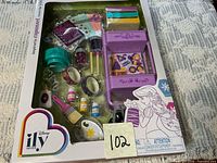 Front of sealed box showing full accessory set