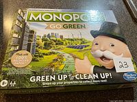 Front of sealed Monopoly Go Green box showing title and artwork