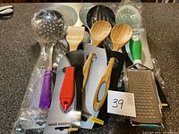 Overview of all nine new packaged kitchen utensils on countertop