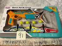 Front view of sealed Arcady Super Air Blaster set showing launcher, balls and gliders