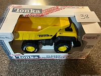 Front angled view of Tonka Classic dump truck in box