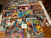 Group shot of all fourteen Superman comic books laid out on table
