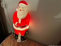Front view of illuminated plastic Santa blow mold