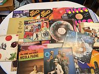 Overall view of approximately 15 LP jackets spread on table