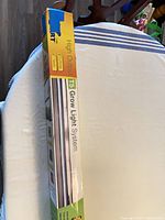 Boxed 4-ft T5 grow light system showing product name and size