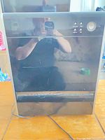 Front view showing control panel, power button and cord