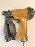Overall view of Bostitch pneumatic coil nailer showing body, magazine, and air fitting
