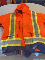Front view of Dakota hi-vis jacket showing color, reflective tape, pockets, hood