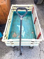 Top view of teal metal bed wagon with pull handle and side rails