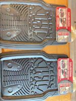 Two black Kraco floor mats with packaging visible