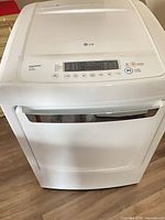 Front and top view of LG electric dryer showing overall condition