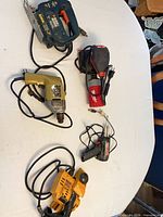 Group shot of five corded tools laid on table