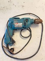 Full view of Makita 8450 drill with cord and rusted chuck