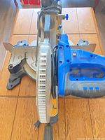 Top view of Mastercraft sliding compound miter saw showing blade, fence, base and blue motor housing