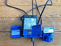 Top view of sharpener with power cord and both blue attachments