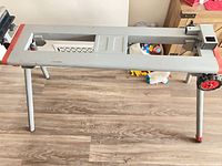 Full view of unfolded Milwaukee miter saw stand showing legs and extensions