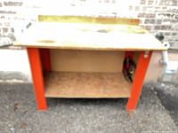 Front view of table showing frame, shelf, and color