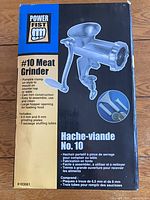 Retail box showing Power Fist #10 cast iron manual meat grinder and listed accessories
