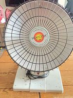 Front view of Presto HeatDish Plus heater showing reflector, guard, base and cord