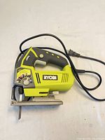 Full view of Ryobi corded jigsaw with cord and blade installed