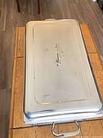 Top view of rectangular stainless steel chafing dish with lid in place