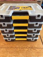 Stack of five Stanley SortMaster organizers showing yellow handles and black bases
