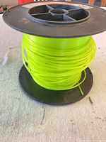 Full spool showing fluorescent yellow line on black reel