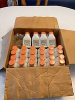 Open carton displaying rows of sealed Stihl oil bottles