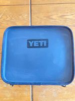 Top view of closed navy YETI soft cooler showing logo and exterior condition