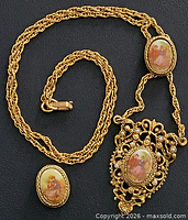 Full view of necklace showing chain, two portrait plaques and filigree pendant