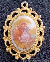 Front view showing porcelain scene and gold-tone frame