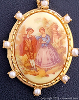 Front view showing Limoges porcelain plaque with courting couple scene and pearl accents