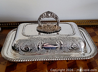 lid with detachable handle attached, showing ornate decoration