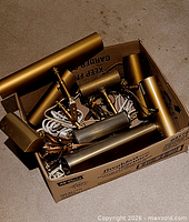 Box containing multiple brass and silver picture lights