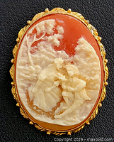 Front view of cameo brooch showing carved scene and frame