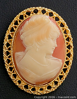 Front view of brooch showing full cameo and gold tone frame