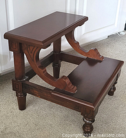 Front angle showing two steps, turned legs, bracket supports