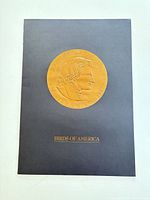 Front of black folder with gold Audubon medallion and Birds of America text