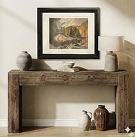 Framed lithograph displayed above console table