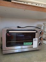 Front and top view of Cuisinart CTO-120PCC convection toaster oven broiler showing stainless exterior, glass door, control knobs and cord