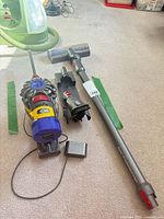 Overall lot showing vacuum body, power head, wand, wall mount and charger