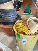 Bin with extension cords and stacked planters
