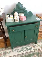 Front view of green painted wash stand with drawer and two doors