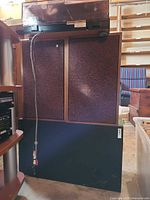 Stacked speakers with Yamaha turntable on top, wiring visible