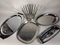 Group shot of five metal serving pieces