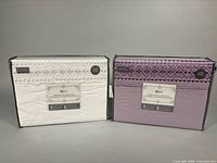 Front view of both boxed sheet sets, white and lavender