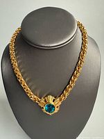 Full view of gold-tone chainlink choker on display bust showing overall design and length