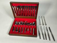 Open chest showing majority of flatware and loose knives